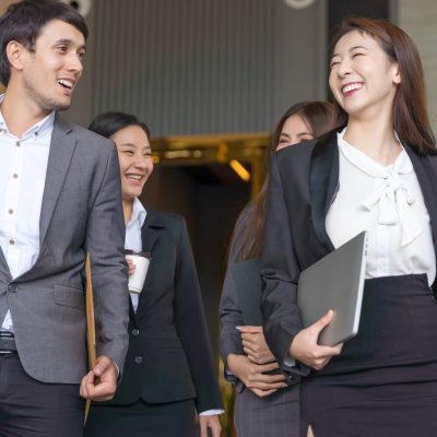 Asian business people walking to go out office building.