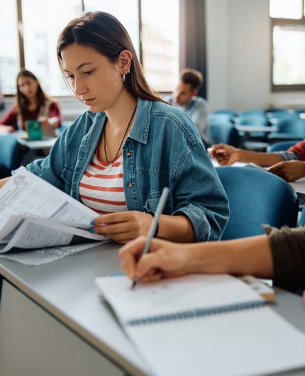 Female student learning during a class at university classroom.