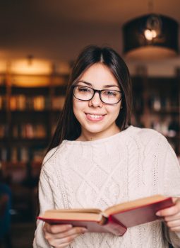 Portrait of a beautiful student in library