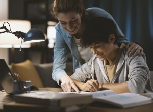 Tutor helping a student with his homework